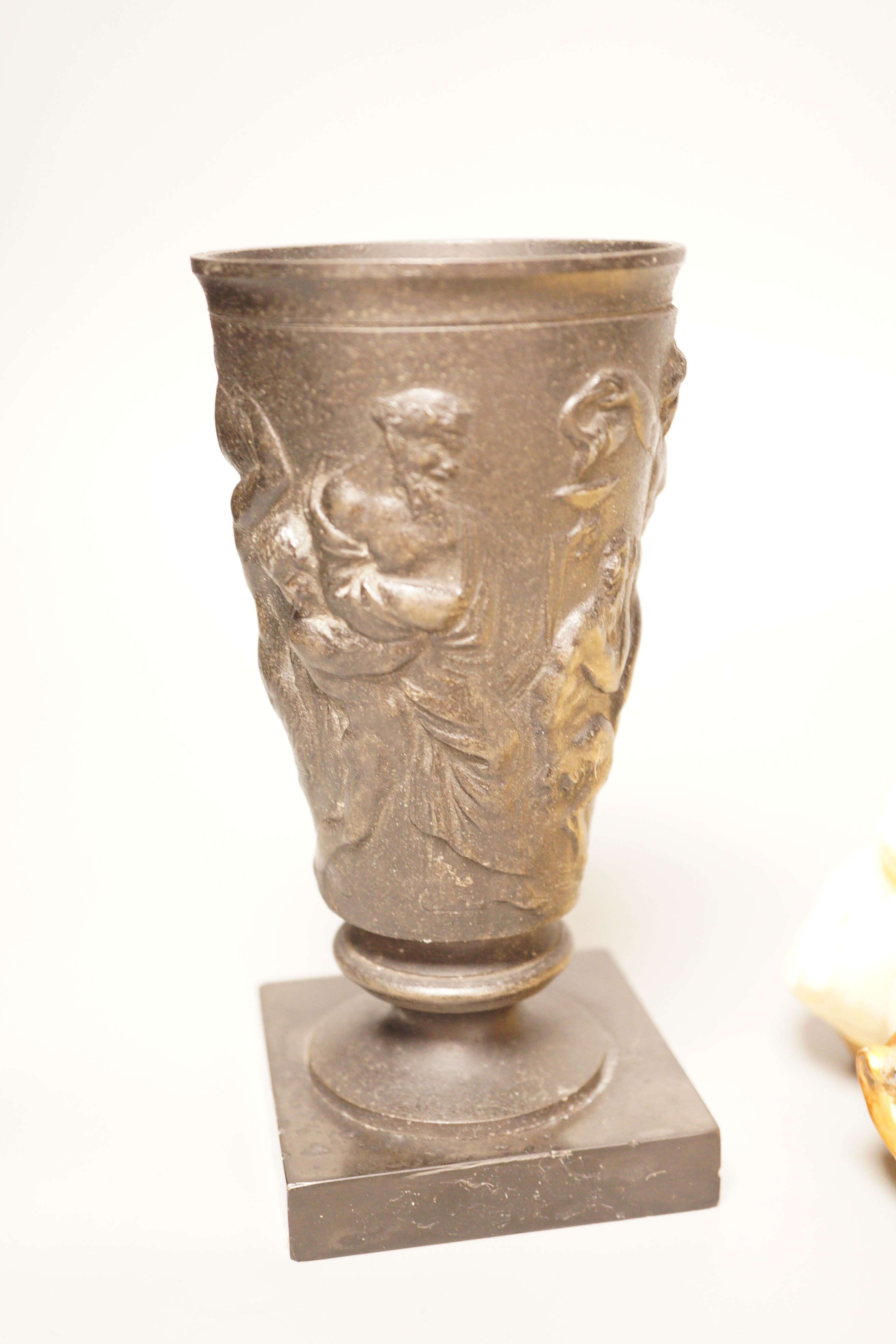 A pair of gilt resin figural wall appliques, signed, and a 19th century cast iron and slate beaker, Sotheby’s label to base, tallest 17cm